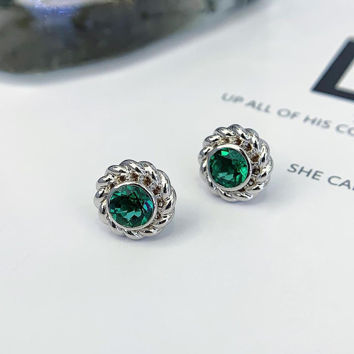 Effortlessly Unforgettable Emerald Halo Studs