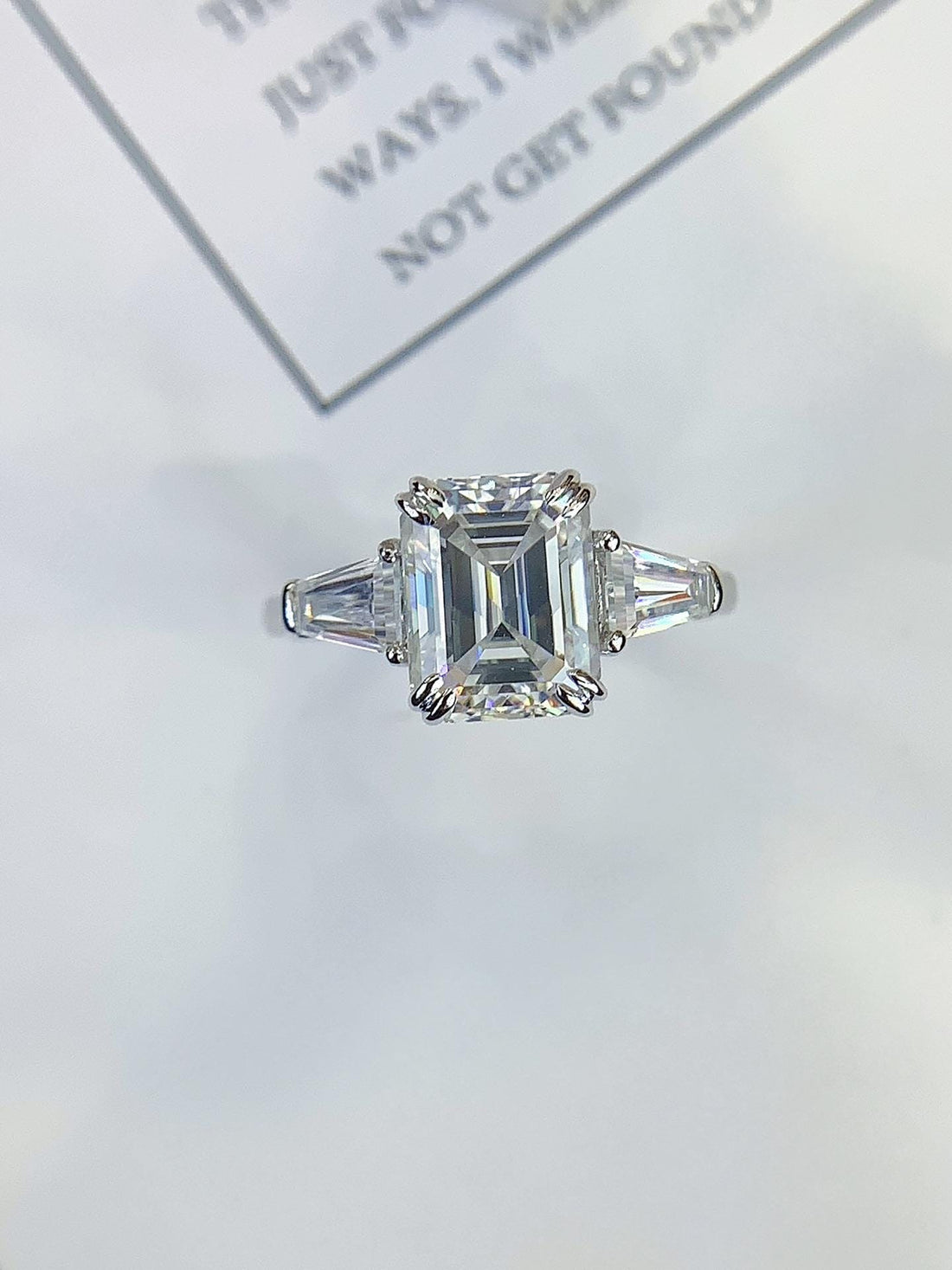 The Ring They'll Ask About Emerald Cut Ring with Trapezoid Side Stones